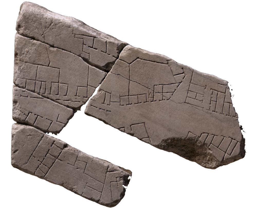 Broken stone fragments of the forma urbis. You can see the lines of roads and buildings marked on them
